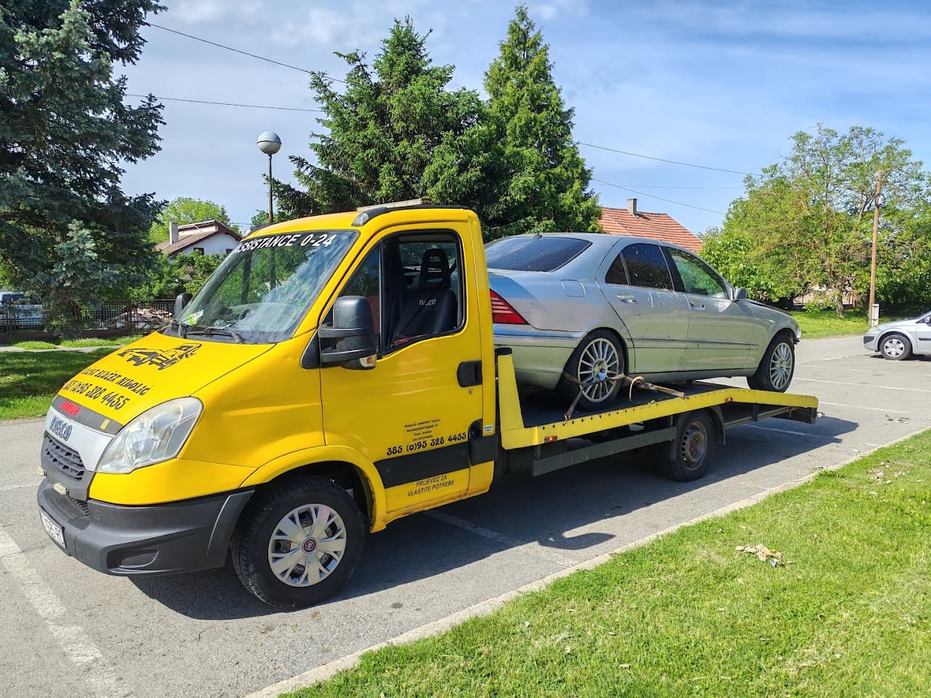 Tow truck with a loaded Mercedes